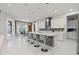 Open kitchen with large island, bar seating, and stylish pendant lighting at 9845 Emerald Berry Dr, Winter Garden, FL 34787