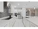 Modern kitchen featuring stainless appliances, white cabinets, and stone backsplash at 9845 Emerald Berry Dr, Winter Garden, FL 34787