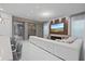 Open-concept living room with large TV, fireplace, and easy access to kitchen at 9845 Emerald Berry Dr, Winter Garden, FL 34787