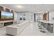 Spacious open-plan living room with bar seating and modern finishes at 9845 Emerald Berry Dr, Winter Garden, FL 34787