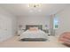 This primary bedroom offers a luxurious king bed, chandelier and mirrored nightstands at 9845 Emerald Berry Dr, Winter Garden, FL 34787