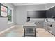 Comfortable office with a built-in desk, storage cabinets, and natural lighting at 9845 Emerald Berry Dr, Winter Garden, FL 34787