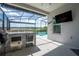 A fully screened outdoor space including bar/kitchen area, seating, and a view of the pool at 9845 Emerald Berry Dr, Winter Garden, FL 34787