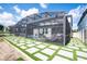 Screened pool with a view of backyard and custom paver-turf design at 9845 Emerald Berry Dr, Winter Garden, FL 34787