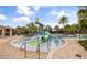 Beautifully designed splash pad with slides and palm trees, perfect for Gathering fun in the sun at 9845 Emerald Berry Dr, Winter Garden, FL 34787