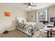 Well-lit bedroom with a white frame bed, neutral-colored walls, and a view overlooking neighborhood at 1031 S Hiawassee Rd # 2517, Orlando, FL 32835