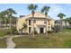 Inviting yellow two-story building with tropical landscaping and classic exterior stairway at 1031 S Hiawassee Rd # 2517, Orlando, FL 32835