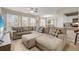 Open-concept living room featuring a large sectional sofa, bright natural light, and modern decor at 1031 S Hiawassee Rd # 2517, Orlando, FL 32835