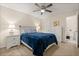 Cozy main bedroom with soft lighting, plush carpet, and ensuite bathroom for added privacy at 1031 S Hiawassee Rd # 2517, Orlando, FL 32835