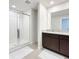 Modern bathroom featuring a glass-enclosed shower, dual sink vanity, and neutral tile floors at 1045 Desert Candle Dr, Ocoee, FL 34761