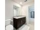 Clean bathroom featuring a granite-topped vanity, a toilet, and tile floors at 1045 Desert Candle Dr, Ocoee, FL 34761