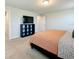 Comfortable bedroom with neutral carpet, and a modern black shelving unit perfect for storage at 1045 Desert Candle Dr, Ocoee, FL 34761