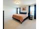Spacious bedroom features neutral carpet, and a stylish bed with complementary side tables at 1045 Desert Candle Dr, Ocoee, FL 34761