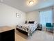 Cozy bedroom with neutral carpet, a floral bedspread, and bright window views at 1045 Desert Candle Dr, Ocoee, FL 34761