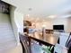 Open dining area with a staircase and a view to the kitchen and living room at 1045 Desert Candle Dr, Ocoee, FL 34761