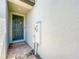 Covered front door with 'Welcome' sign and brick entrance, with white textured walls at 1045 Desert Candle Dr, Ocoee, FL 34761
