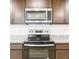 Updated kitchen featuring stainless steel appliances, granite countertops, and stylish wood cabinetry at 1045 Desert Candle Dr, Ocoee, FL 34761