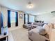 Living room featuring a gray sectional sofa, neutral walls, and a view of the backyard at 1045 Desert Candle Dr, Ocoee, FL 34761