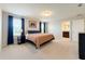 Bright main bedroom featuring neutral carpet, and a stylish bed with complementary side tables at 1045 Desert Candle Dr, Ocoee, FL 34761