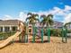 Community playground featuring a slide, climbing structures, and pea gravel ground covering at 1045 Desert Candle Dr, Ocoee, FL 34761