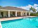Community pool featuring shallow entry steps, lounge area and covered patio with seating at 1045 Desert Candle Dr, Ocoee, FL 34761