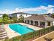 Resort-style pool with comfortable lounge chairs and a covered pavilion, ideal for relaxation and social gatherings in the community at 1045 Desert Candle Dr, Ocoee, FL 34761