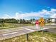Trail crossing with clear signage ensuring safe passage for pedestrians, cyclists, and vehicles within the community at 1045 Desert Candle Dr, Ocoee, FL 34761
