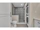 Updated bathroom features patterned tile in shower and stackable washer/dryer at 1120 Courtland St, Orlando, FL 32804