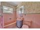 This bathroom features unique wallpaper, a classic pink tub, and a vintage vanity at 1120 Courtland St, Orlando, FL 32804