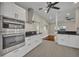 Well-equipped kitchen featuring built-in appliances, white cabinetry, and modern design at 1120 Courtland St, Orlando, FL 32804