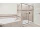 Modern bathroom features a tiled shower with glass doors, and soaking tub at 11258 Whistling Pine Way, Orlando, FL 32832