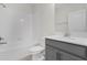 Bright bathroom features a shower-tub combo and gray vanity with a white countertop at 11258 Whistling Pine Way, Orlando, FL 32832