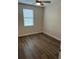 Cozy bedroom with ceiling fan, wood-look flooring, and a window at 11258 Whistling Pine Way, Orlando, FL 32832