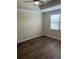 Clean bedroom features a ceiling fan, wood-look flooring, and window at 11258 Whistling Pine Way, Orlando, FL 32832