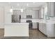 Modern kitchen featuring stainless steel appliances, gray cabinets, and a center island at 11258 Whistling Pine Way, Orlando, FL 32832