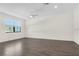 Spacious living room with wood-look flooring, ceiling fan, and bright natural light at 11258 Whistling Pine Way, Orlando, FL 32832