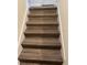 Stairway with wood-look laminate flooring and a clean, modern design at 11258 Whistling Pine Way, Orlando, FL 32832