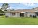 Exterior shot of the back of the home, showcasing backyard, patio and grass at 1156 Lucaya Cir, Orlando, FL 32824