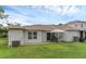 Exterior shot of the back of the home, showcasing backyard, patio and grass at 1156 Lucaya Cir, Orlando, FL 32824