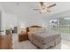 Bright bedroom with a large window and a ceiling fan at 1156 Lucaya Cir, Orlando, FL 32824