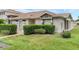 Well-manicured front yard of a cozy single-story home with a tiled walkway at 1156 Lucaya Cir, Orlando, FL 32824