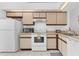 Well-equipped kitchen with classic white appliances and ample cabinetry at 1156 Lucaya Cir, Orlando, FL 32824
