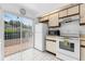 Bright kitchen featuring white appliances and a sliding door to patio at 1156 Lucaya Cir, Orlando, FL 32824