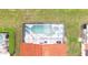 Aerial shot of a screened in pool and patio area with lounge chairs and umbrella at 117 Rosso Dr, Davenport, FL 33837
