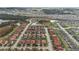Aerial view of a residential area with red tile roofs, green lawns, and palm trees at 117 Rosso Dr, Davenport, FL 33837