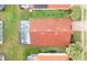 Aerial view of the back of a red tile roofed house and screened-in pool at 117 Rosso Dr, Davenport, FL 33837