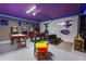 Spacious finished basement featuring arcade games, table games, and colorful décor for entertaining at 117 Rosso Dr, Davenport, FL 33837
