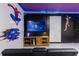 Finished basement featuring a large entertainment center with gaming console and superhero themed decorations at 117 Rosso Dr, Davenport, FL 33837