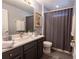 Bathroom features a vanity with a dark countertop, and shower/tub with a gray curtain at 117 Rosso Dr, Davenport, FL 33837