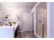 Bathroom featuring double sinks with framed mirrors and glass enclosed shower at 117 Rosso Dr, Davenport, FL 33837